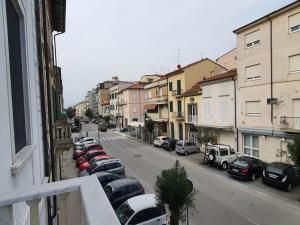 a view of a street with cars parked on the street at Foscolo 27 a 100 m dal mare in Viareggio