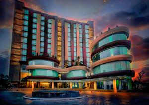 a hotel with a building with a sunset in the background at Grand Soll Marina Hotel in Tangerang