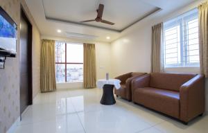 a living room with a couch and a table at HOTEL VINTAGE CASTLE in Coimbatore