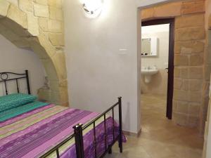 A bed or beds in a room at Masseria Cricelli