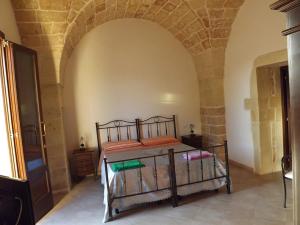 A bed or beds in a room at Masseria Cricelli
