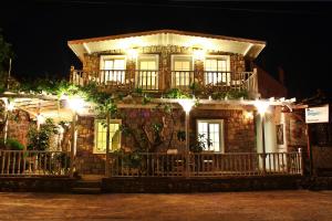 a brick house with lights on it at night at Losta Sahil Evi 2 in Selimiye
