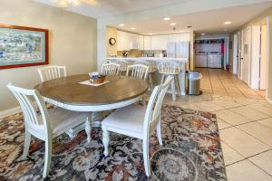 a kitchen and dining room with a wooden table and chairs at Emerald Isle in Pensacola Beach