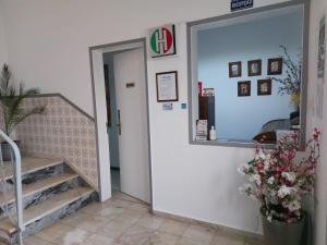 a entrance to a building with stairs and a mirror at Hospedaria A Italiana in Moura +6 photos