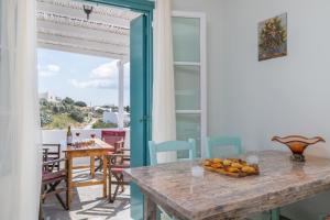 a dining room with a table and a view of the ocean at Zanart maisonette II in Tripití