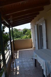 a room with a table and a balcony with a view at Villa Ioanna in Koroni