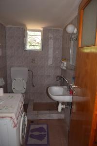 a small bathroom with a sink and a toilet at Villa Ioanna in Koroni