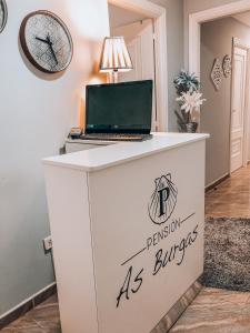 a desk with a laptop on top of it at Pensión As Burgas in Caldas de Reis