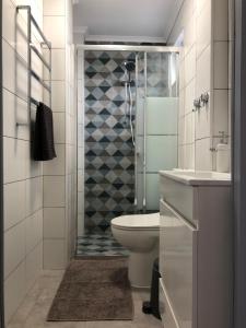 a bathroom with a shower and a toilet and a sink at Casa do Viajante - Suite in Zambujeira do Mar +17 photos
