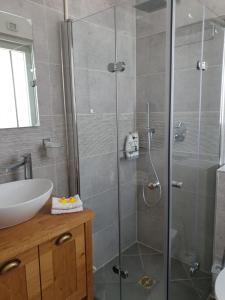 a bathroom with a shower and a sink at sea view in ‘Akko
