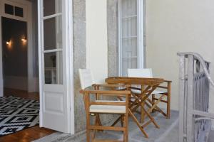 a wooden table and chairs sitting next to a door at Bonjardim 466 - Historic Townhouse in Porto +22 photos