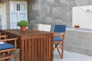 a wooden table with two chairs and a potted plant at Bonjardim 466 - Historic Townhouse in Porto