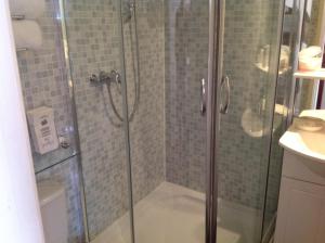 a shower with a glass door in a bathroom at The Montclair in Blackpool