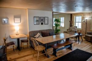 a living room with a couch and a table at Brook Road Inn in Goshen