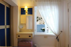 a bathroom with a mirror and a sink and a window at Losta Sahil Evi 2 in Selimiye