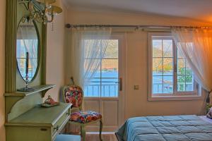 a bedroom with a bed and a mirror and a window at Losta Sahil Evi 2 in Selimiye