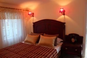 a bedroom with a large bed with two pillows at Losta Sahil Evi 2 in Selimiye