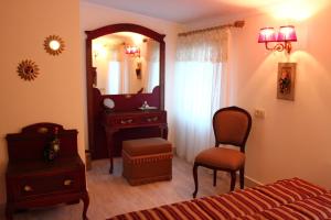 a bedroom with a bed and a mirror and a chair at Losta Sahil Evi 2 in Selimiye