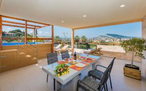a dining room with a table and chairs on a balcony at Zante Sky Suites in Argasi