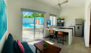 una cocina con mesa y una cocina con refrigerador en Aqua Guesthouse, en Puerto Morelos