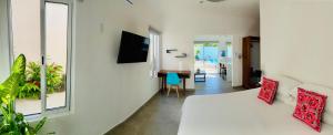 1 dormitorio con cama, espejo y pasillo en Aqua Guesthouse, en Puerto Morelos