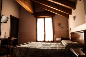 Postel nebo postele na pokoji v ubytování Ristorante Albergo da Giovanni