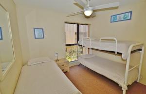a bedroom with two bunk beds and a window at Riverview Holiday Apartment 12 - Kalbarri WA in Kalbarri +8 photos