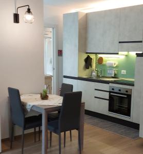 a kitchen with a table and chairs in a kitchen at MAISON MY LIFE in Bolzano