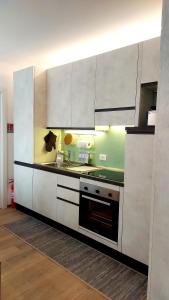 a kitchen with white cabinets and a stove at MAISON MY LIFE in Bolzano