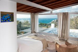 a bedroom with a bed and a view of the ocean at Lilly's Home -2 Bedrooms in Mýkonos City