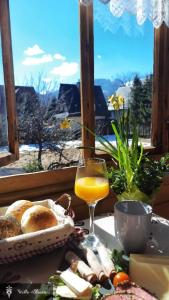 a table with a plate of food and a glass of orange juice at Willa Blanca Zakopane in Zakopane