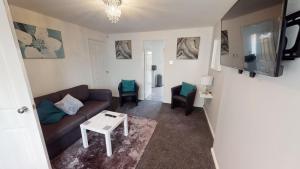 a living room with a couch and a table at Marina House in Hull