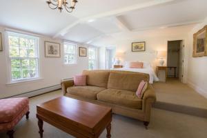 a living room with a couch and a bed at Kedron Valley Inn in Woodstock