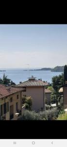 a view of a house with a view of the water at VALLE FIORITA 42 - Lake view Studio in Gardone Riviera