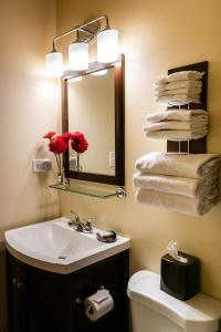 a bathroom with a sink and a mirror and towels at Discovery Inn in Friday Harbor