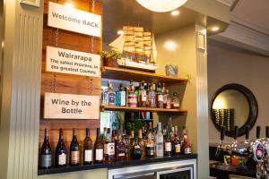 a bar with a bunch of bottles of wine at The White Swan Hotel in Greytown