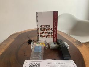 a table with a remote control and a book at Motel Rokka in Guadalajara