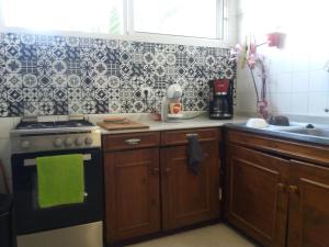 a kitchen with a stove and a sink at near airport in Las Lagunas