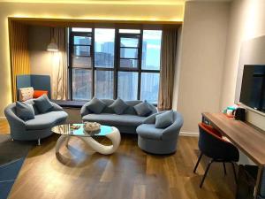 a living room with a couch and a table at Holiday Inn Express - Wuhan Optical Valley, an IHG Hotel in Wuhan