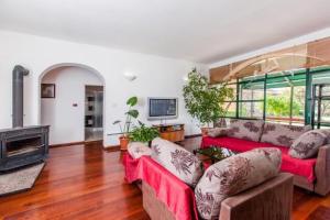 a living room with two couches and a fireplace at Apartments Katja in Trogir