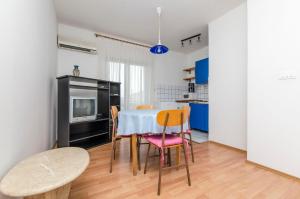 a kitchen and dining room with a table and chairs at Apartments Katja in Trogir