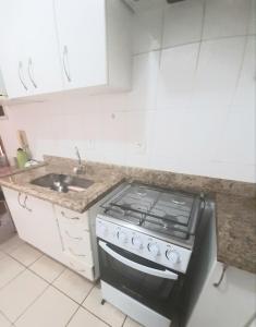 cocina con fogones y fregadero en Flats for you Bueno, en Goiânia
