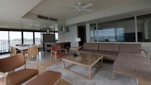 a living room with a couch and a table at MB GALLERY CHATAN by THE TERRACE HOTELS in Chatan