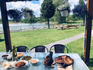 a table with a turkey and other food on it at Villa in Vistytis in Vištytis