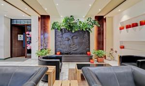 a restaurant with a large vase with a face on it at Treebo Trend Astor HSR Layout in Bangalore