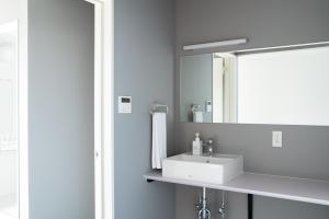 a bathroom with a white sink and a mirror at Koshomachi Stay in Kanazawa