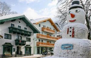 a snowman in front of a building with a house at Gorgeous Apartment In Wagrain With Wifi in Wagrain