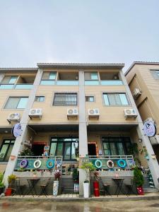 a tall building with windows and plants in front of it at Er Jie's House in Jinning