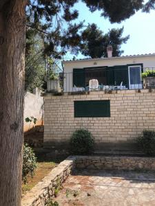 a house with a brick wall at Holiday home Pavarotti in Supetar