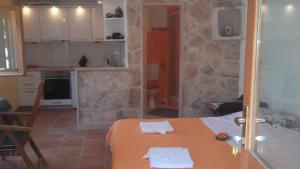 a kitchen with a table with white towels on it at Holiday home Pavarotti in Supetar